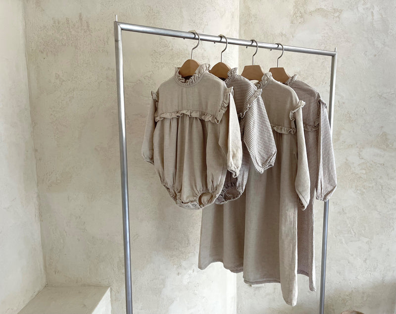 Colour - Natural dark beige   Girls long, flowy A-Line dress featuring a beautiful high ruffled neckline design with the same ruffle flowing through the front section and top of arms.   Matching baby Rompers available 